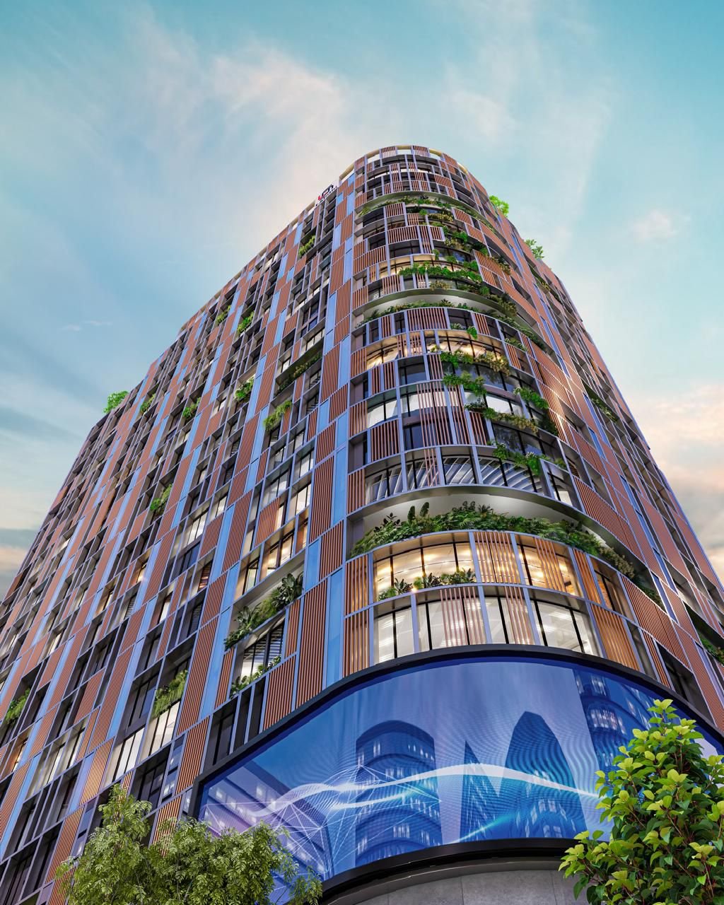 Upward view of BKC EDGE – a modern high-rise commercial building in Bandra Kurla Complex, showcasing its tall glass façade and architectural symmetry from the ground level.