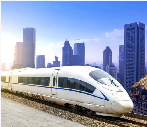 Metro train passing through modern city buildings