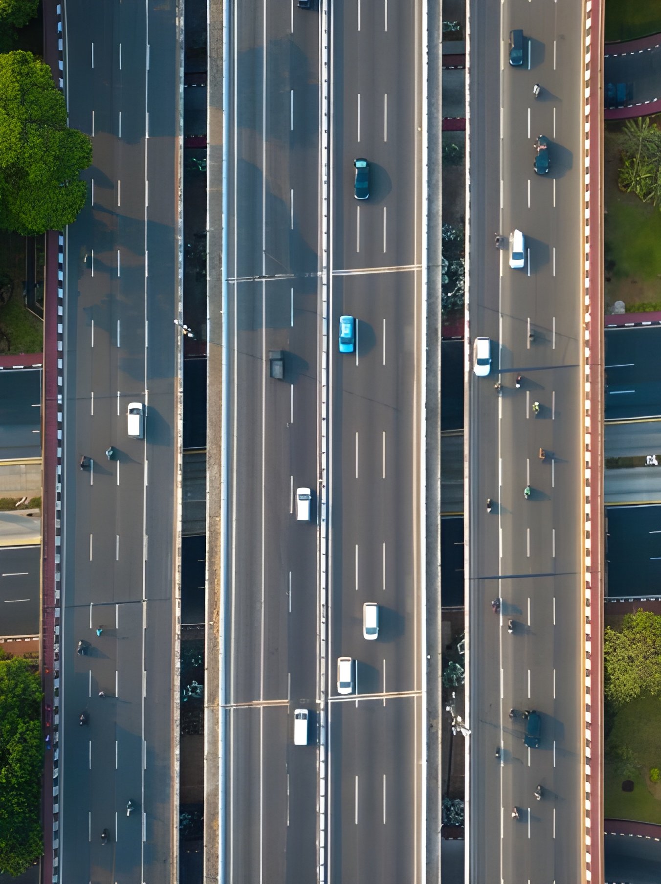 Aerial view of busy city roads with moving cars and intersections.