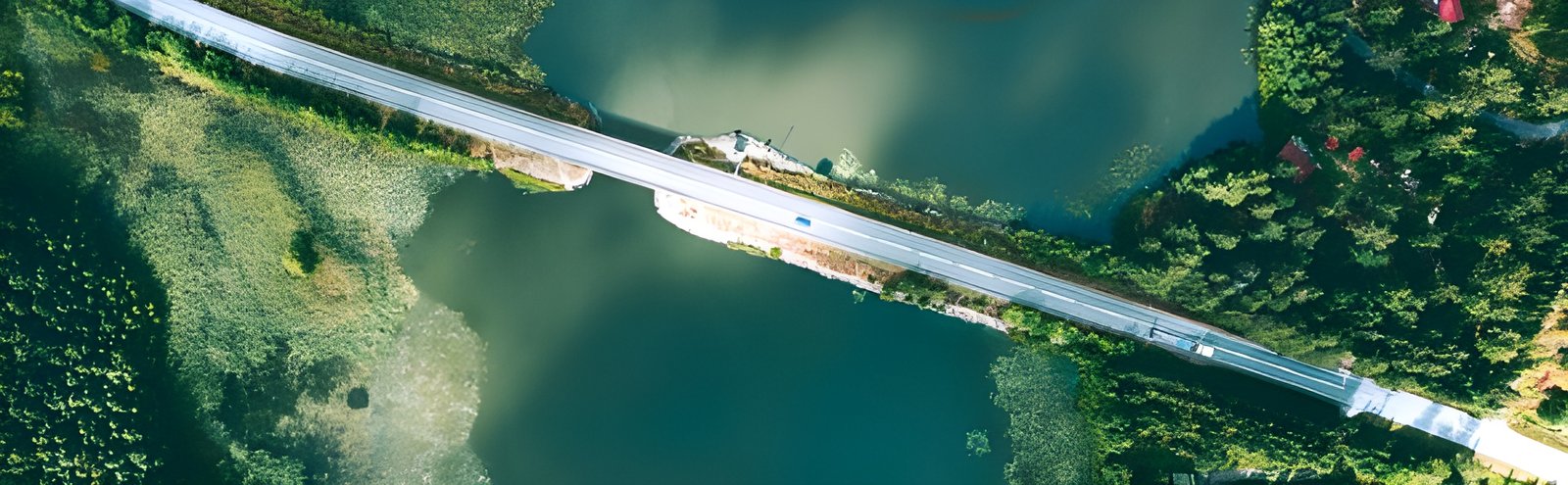 Aerial view of a bridge over water with cars passing on it.